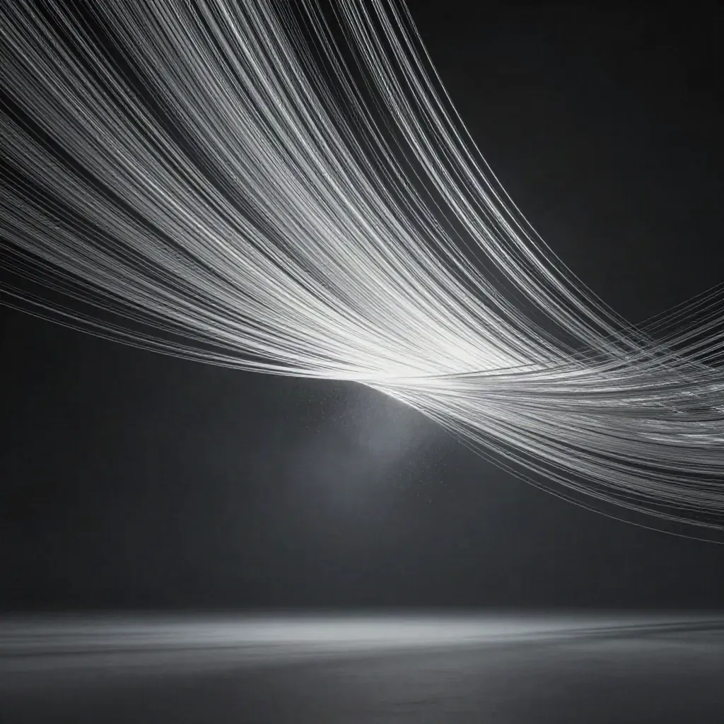 Silver filaments converge into a soft white bloom in a dark graphite void.